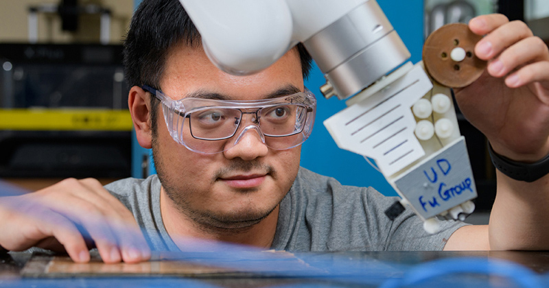University of Delaware Assistant Professor Kun (Kelvin) Fu, with the Department of Mechanical Engineering, is leading a research project supported by $2.5 million in funding from the Department of Energy to develop a new and unique way to manufacture lighter and more energy-efficient parts for vehicles through 3D printing of continuous carbon fiber and thermosetting composites. University of Delaware Assistant Professor Kun (Kelvin) Fu, with the Department of Mechanical Engineering, is leading a research project supported by $2.5 million in funding from the Department of Energy to develop a new and unique way to manufacture lighter and more energy-efficient parts for vehicles through 3D printing of continuous carbon fiber and thermosetting composites.