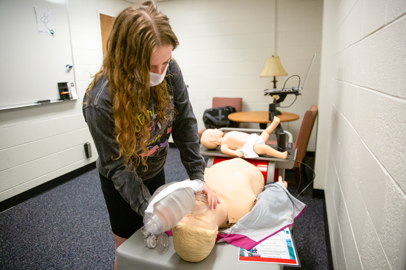 To pass her quarterly CPR skills test for the Resuscitation Quality Improvement project, nursing major Mackenzie Sekya must deliver an appropriate number of breaths to the mannequin within a certain timeframe.  