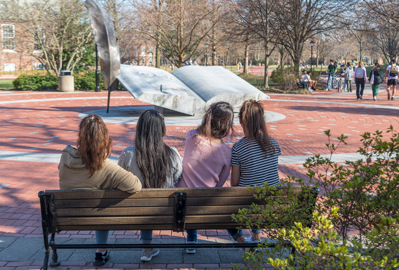 “We are set to learn as much from the women as they are from us,” said Lt. Adrienne Thomas Benevento, an instructor of the self-defense class UDPD is leading for the University’s new Afghan students, four of whom are pictured sitting on the edge of the Mentor’s Circle on campus.