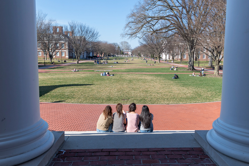  Inspired by their harrowing escape from the Taliban in August, UD helped place 56 Afghan women, all college students, at universities around the country. Pictured here are four of the 15 evacuees now studying at UD. To protect their identities, and the identities of loved ones back home, they are photographed only from behind. 