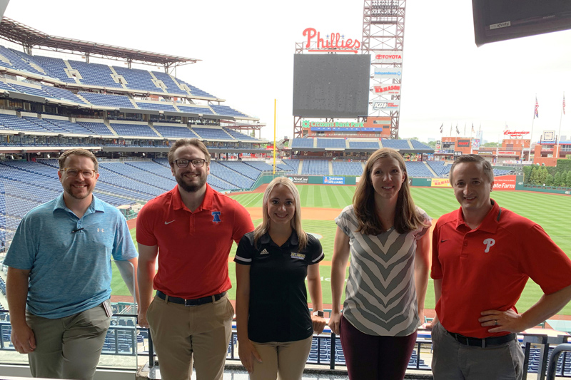 At Citizens Bank Park, from left to right, are Ricker Adkins, assistant professor and clinical education coordinator  at Thomas Jefferson University and UD alumni Class of 2010; Matt Schofield, assistant athletic trainer at Campbell University; Bethany Hannum, UD athletic training senior; Erin Pletcher, assistant professor, Thomas Jefferson University;  Stephen Thomas, associate professor and department chair of exercise science at Thomas Jefferson University, and UD doctoral alumni, Class 2010