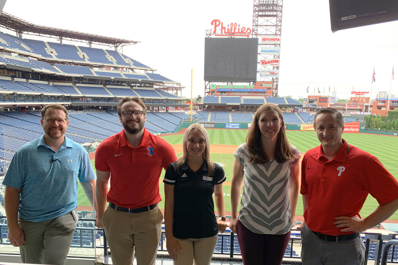 At Citizens Bank Park, from left to right, are Ricker Adkins, assistant professor and clinical education coordinator at Thomas Jefferson University and UD alumni Class of 2010; Matt Schofield, assistant athletic trainer at Campbell University; Bethany Hannum, UD athletic training senior; Erin Pletcher, assistant professor, Thomas Jefferson University; Stephen Thomas, associate professor and department chair of exercise science at Thomas Jefferson University, and UD doctoral alumni, Class 2010 At Citizens Bank Park, from left to right, are Ricker Adkins, assistant professor and clinical education coordinator at Thomas Jefferson University and UD alumni Class of 2010; Matt Schofield, assistant athletic trainer at Campbell University; Bethany Hannum, UD athletic training senior; Erin Pletcher, assistant professor, Thomas Jefferson University; Stephen Thomas, associate professor and department chair of exercise science at Thomas Jefferson University, and UD doctoral alumni, Class 2010