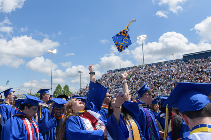 Graduates of the Class of 2022 throw their caps in the air in celebration of Commencement. Graduates of the Class of 2022 throw their caps in the air in celebration of Commencement.