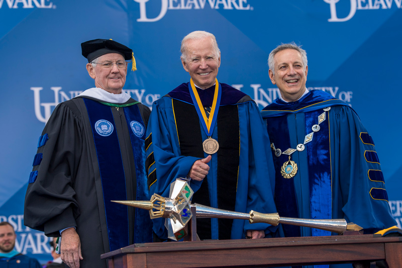 John Cochran, Chairman of the Board of Trustees; President Joe Biden; and UD President Dennis Assanis stand in front of the University’s mace, a symbol of power and authority that signifies the dignity of an institution. Biden was presented with one of UD’s highest honors, the Medal of Distinction.