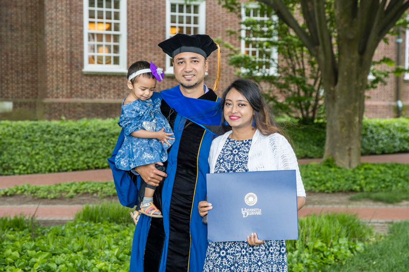 Istiaque Alam holds his 1 ½-year-old daughter, Inaya, after receiving his doctoral hood in mechanical engineering. Alam said the support of his wife, Tasmiah Rawnuck, was crucial to his success.