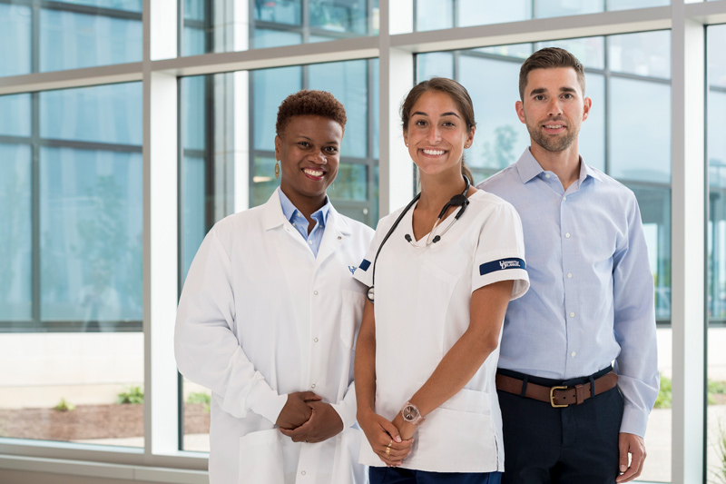 From left to right, Adrienne Pinckney, assistant professor of instruction in the Department of Physical Therapy; Chris Martens, assistant professor in the Department of Kinesiology and Applied Physiology and Sofia Moderno, a 2021 graduate of College of Health Sciences’ School of Nursing, pose for photoshoot for a CHS billboard in the science, Technology and Advanced Research (STAR) Campus Tower. 