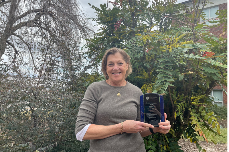 Sue Barton stands with her 2021 Worrilow Award outside of Townsend Hall.