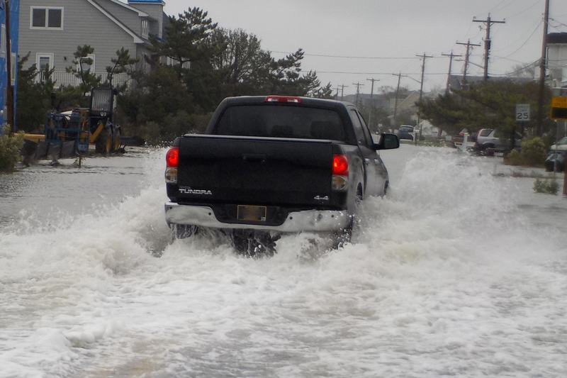 A truck tries to drive through flood waters on Cedar Street in Lewes. 