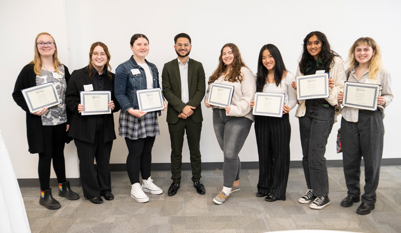 Eight students were awarded prizes in the 2022 Common Reader Essay Contest, in response to Badr's book. From left to right: Michaela Hodges-Fulton (honorable mention), Annie Blimmel (second place), Amelia Seydel (fourth place), Ahmed M. Badr (Common Reader author), Isabella Thiele (third place), Hannah Feng (honorable mention), Diya Jackson (honorable mention) and Sophia DiFabio (honorable mention). Not pictured: Kabmata Kargbo (first place).
