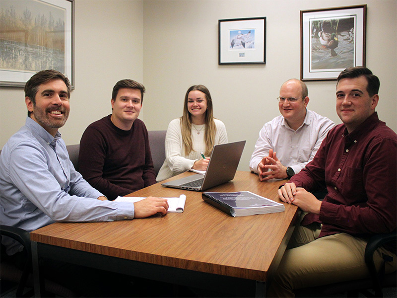 The Grant Assistance Program team meets to discuss next steps for collaborating with Delaware municipalities to obtain infrastructure funding. From left to right, Matt Harris, Chase Barnes, Jenna Mayhew (undergraduate Public Administration Fellow), Troy Mix, and Collin Willard (graduate Public Administration Fellow).