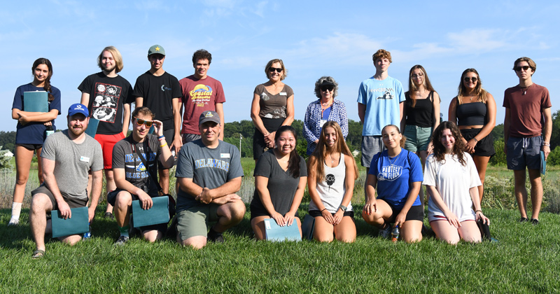 Students pose for a class photo atop an elevated grass mound located in the heart of the Oudolf Meadow Garden. 