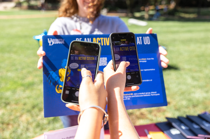 Students scan a QR code that brings them to the TurboVote website, making registering to vote easy and accessible.