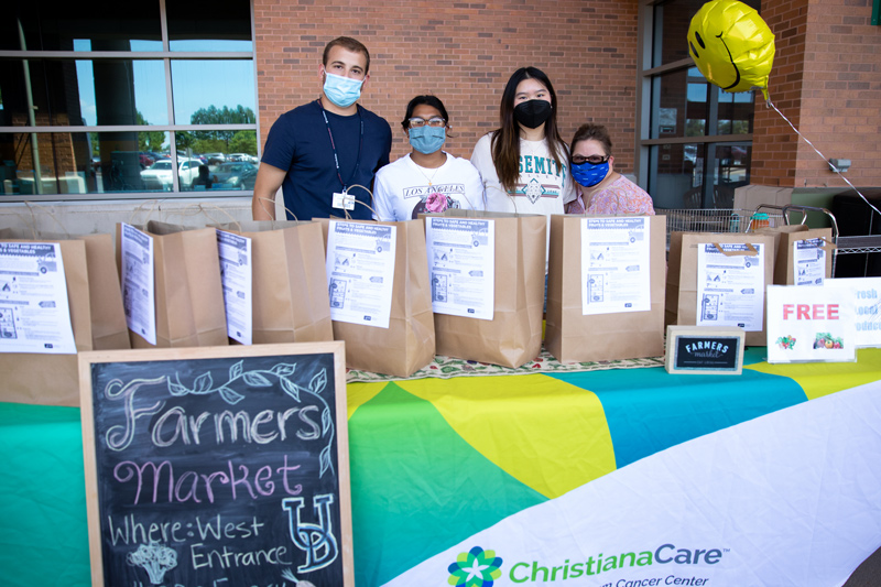 UD student Robert Weimer (far left) volunteered at the farmers market as part of his internship and he is shown here with volunteers Christina Lake, Isabella Jiang, and Adrika Gunin. 