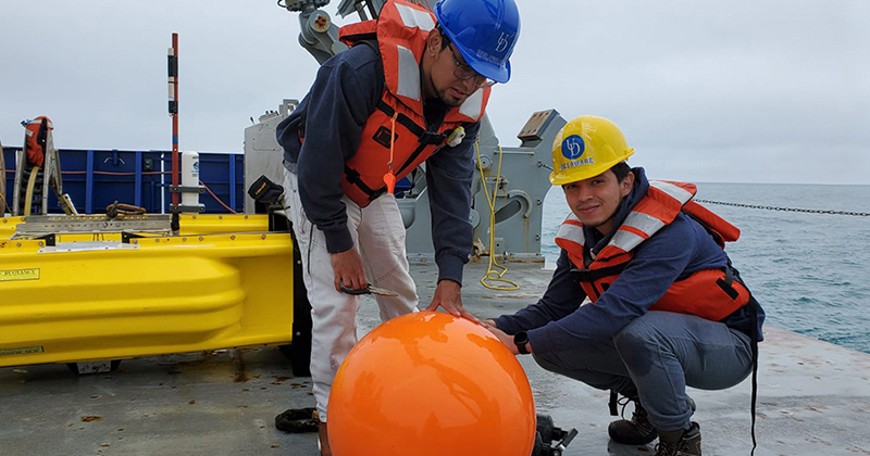 Christian Escobar (left) and Jhon Castro, doctoral electrical and computer engineering students at the University of Delaware, recover equipment at the end of an experiment off the coast of New England to collect data that will be used to develop machine learning techniques to produce algorithms showing how underwater sounds change over time and across distances.