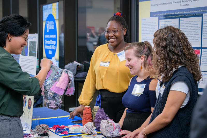  UD graduate student Sun Woo Park (left) learns about “Mapping the Wasteshed” research, which aims to re/sourcing food and textile waste, from students Diadem Abayode, Michelle Yatvitskiy and Miranda Rack.