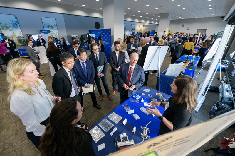 The University of Delaware brought many members of its robust research operations to Washington, D.C. on Wednesday, Sept. 21 to demonstrate the University's efforts and expertise to leaders of Congress and federal agencies that provide funding for such research. In this photo, doctoral student Stephanie Matz explains hydrogen fuel research to Delaware U.S. Sen. Chris Coons and others at Wednesday's event.