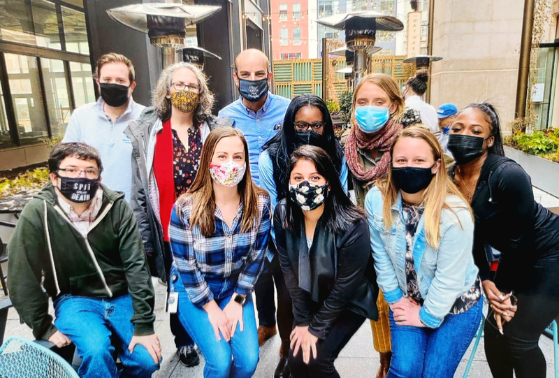 Colten Strickland (back left) poses with his team at the Philadelphia Department of Public Health, where he developed a surveillance system to monitor COVID deaths, while completing his doctoral studies.