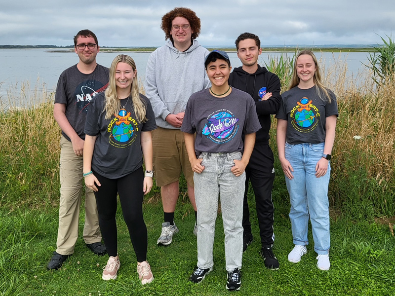 A team of University of Delaware students traveled to Virginia in June 2022 to watch the launch of a sounding rocket — with their experiments aboard — from NASA’s Wallops Island Facility. The team, mentored by Prof. Bennett Maruca, included (left to right): Calvin Adkins, Andrea Duckenfield, Isaac Chandler, Dax Moraes, Jeffrey Neumann and Valerie Moore.