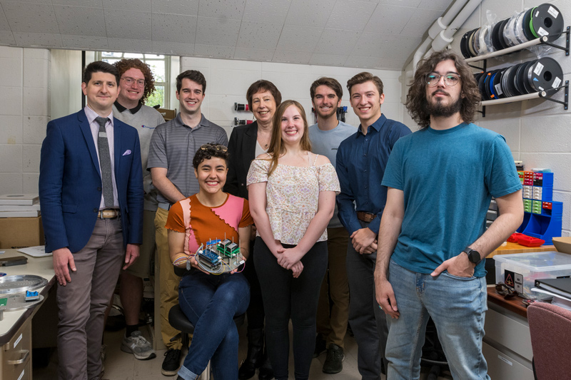 University of Delaware physicist Bennett Maruca (left) and members of his 2023 team talked about the experiment they planned to launch aboard a NASA sounding rocket this year during a May visit with Nicola “Nicky” Fox, chief of NASA’s science mission directorate. From left: Bennett Maruca, Isaac Chandler, Jarod Dagney, Dax Moraes, Nicky Fox, Allison Fantom, T.J. Kaifer, Nick Ulizio and Miguel Mercado.