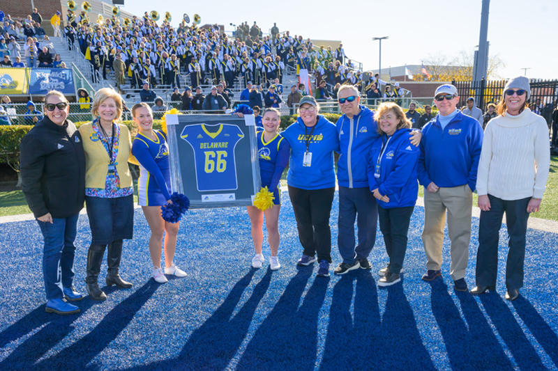 UD Marching Band Director Heidi Sarver is recognized with a jersey