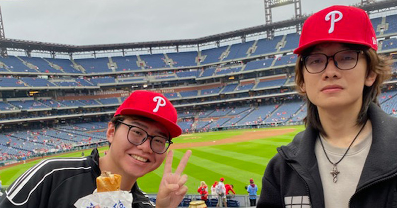 Yihong Chen (left) and Zhixiang Chen, students from Chengdu, China, attend a Phillies game. Yihong Chen (left) and Zhixiang Chen, students from Chengdu, China, attend a Phillies game.