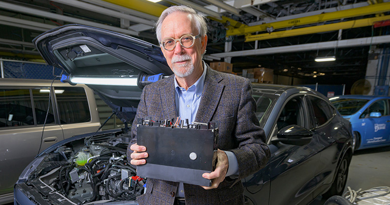 UD’s Willett Kempton holds an electric vehicle (EV) battery module in his research lab at UD’s Science, Technology and Advanced Research (STAR) Campus. Kempton and his team are partnering with industry to develop technology and international standards that accelerate the electrification of transportation and the integration of electric vehicles with the power grid.  
