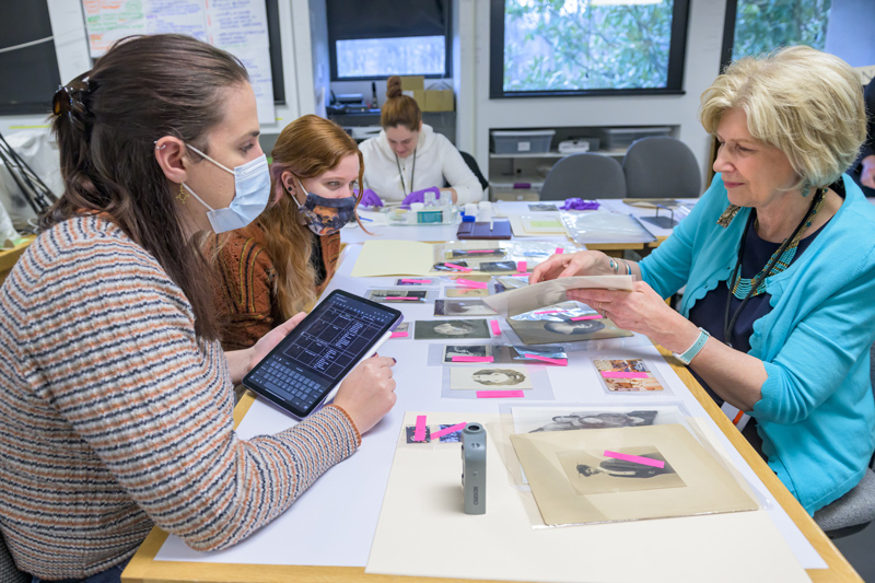 Professor Debra Hess Norris, right, works with students, from left, Riley Thomas, Victoria Kenyon and Maria Julia Costa. Professor Debra Hess Norris, right, works with students, from left, Riley Thomas, Victoria Kenyon and Maria Julia Costa.