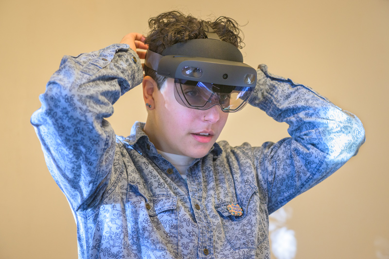 Margalit Schindler, a graduate of the Winterthur/UD Program in Art Conservation and now principal conservator with Pearl Preservation, adjusts the HoloLens 2 headset before beginning a walk-through of Rockwood Museum. Margalit Schindler, a graduate of the Winterthur/UD Program in Art Conservation and now principal conservator with Pearl Preservation, adjusts the HoloLens 2 headset before beginning a walk-through of Rockwood Museum.