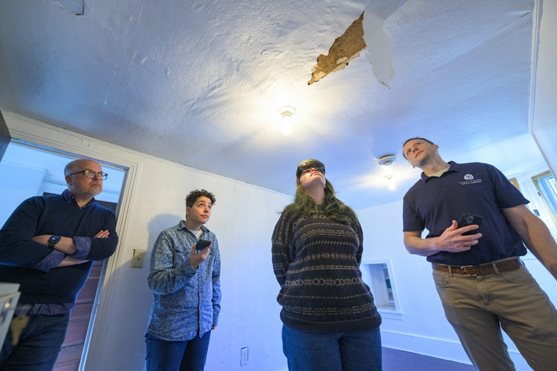 Examining some damage to an upstairs ceiling in the museum are (from left) Ryan Grover, Margalit Schindler, Morrigan Kelley and Tim Leefeldt.