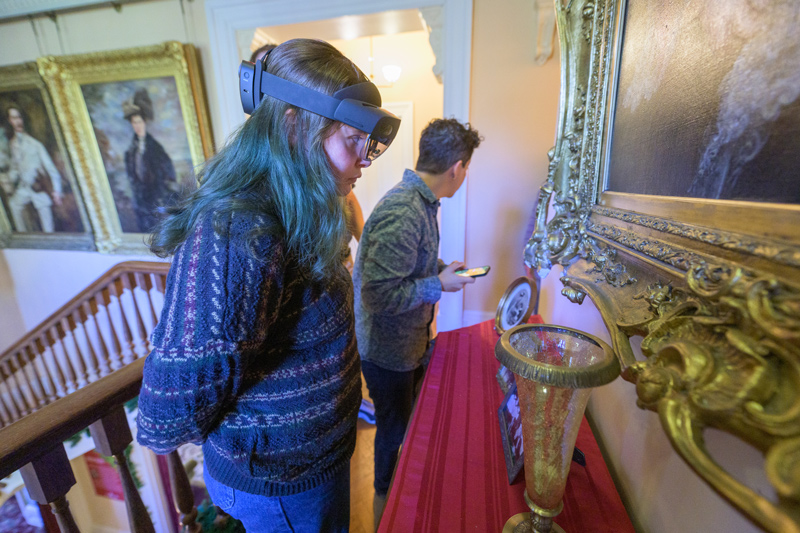 Morrigan Kelley (left) wears augmented reality goggles to transmit images of a painting in the Rockwood Museum, while Margalit Schindler examines other details of the museum.