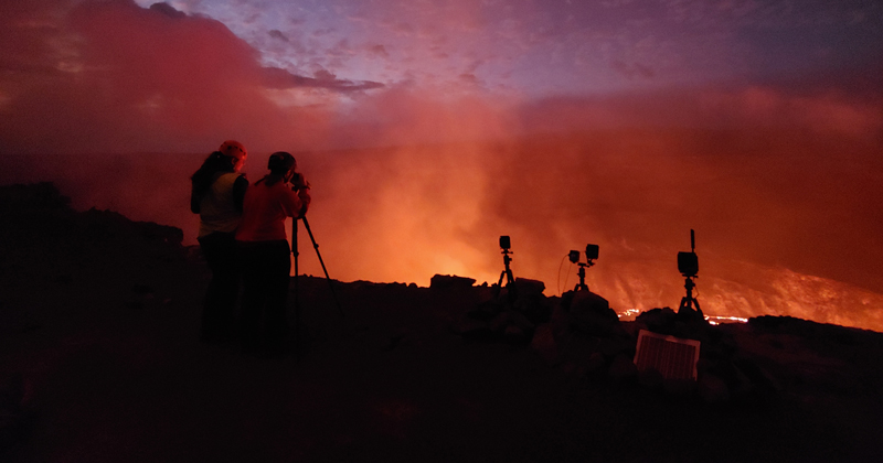 Abigail Nalesnik looks through a rangefinder at the eruption at Kīlauea on the evening of Sept. 30, 2021. She was on the first response team from the U.S. Geological Survey’s Hawaiian Volcano Observatory to visit the eruption and helped make measurements of the active fountains and monitor the lava lake level to track how quickly it was rising. 