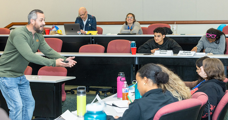 Decorated former Marine Dennis Derr engages with students at the SYLP Economics Summer Camp in June. Decorated former Marine Dennis Derr engages with students at the SYLP Economics Summer Camp in June.