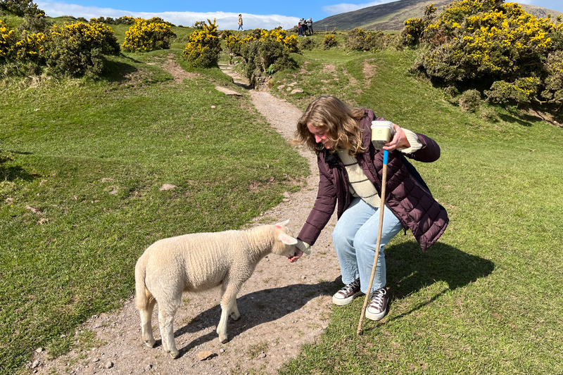UD nursing major Lauren Maransky stops in her travels to pet a goat. 