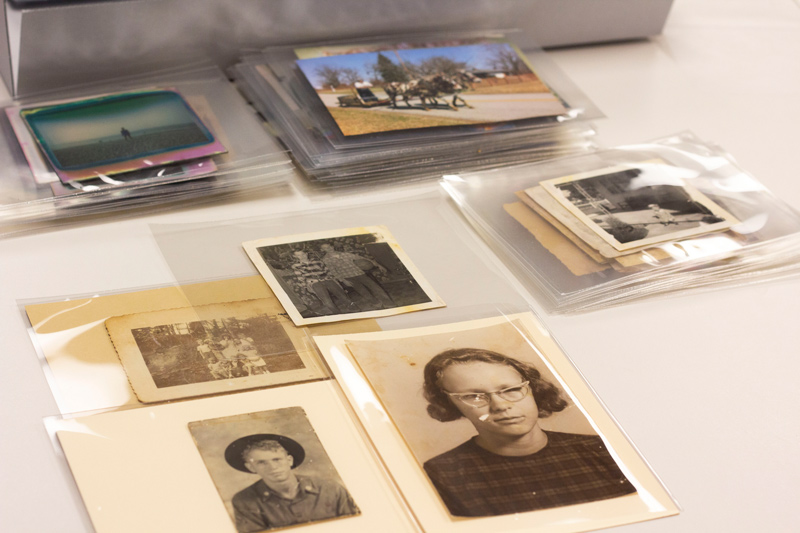 After cleaning and treatment, the restored photographs are placed in archival quality materials to preserve them for the family.