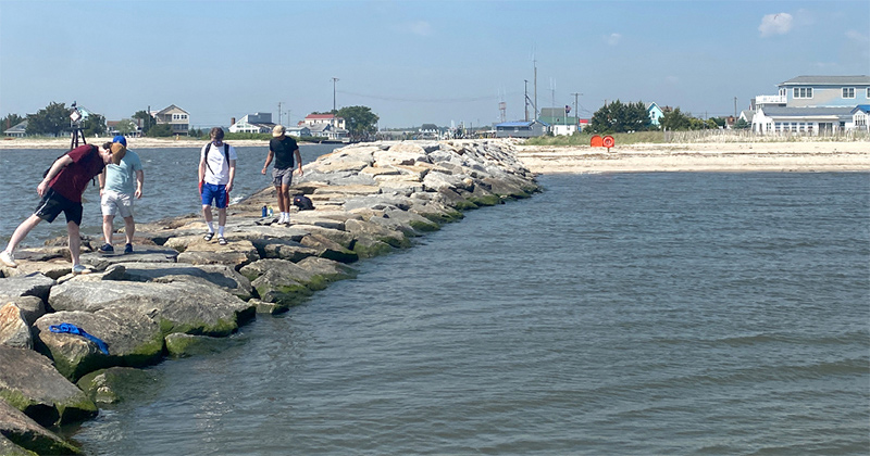 A group of CRDS students explore the recently renovated southern jetty of Bowers Beach at the inlet of the Murderkill River and investigate marine life between the rocks.