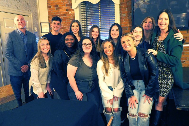 University of Delaware students and their alumni advisers celebrated at a local restaurant in Newark after completing the national Bateman Case Study Competition. From left, top row: Steve Momorella (faculty adviser), Michael Vigneron, Laurel Hannigan, Randi Cohen, Brooke Taback, Brittany Zeigler, and professional advisers Heddy DeMaria and Grace Leong. From left, bottom row: Sam Slimowicz, Karrine Coleman, Erin McGay, Julia Lelio, and Stella Galli.