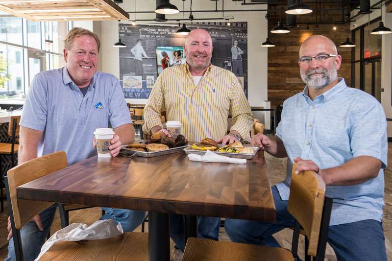 Grain Craft Bar + Kitchen co-owners Lee Mikles (left) and Jim O’Donoghue (center) and general manager Pete Krause are UD alumni.