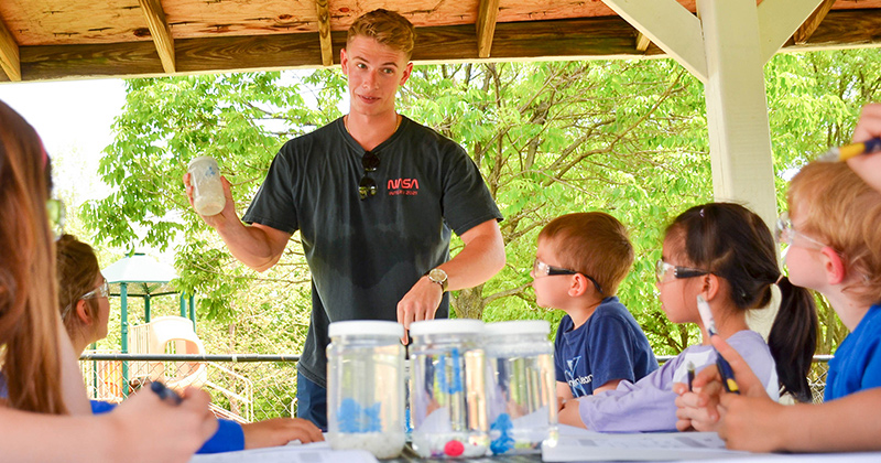 UD 2023 graduate Brenden Swanik (center) explains to pre-K students from UD’s Early Learning Center how to do their own “CubeLab” experiments. Swanik, along with fellow alumni Andrew Marino and Nick Ulizio, translated their senior design project into an outreach activity. 