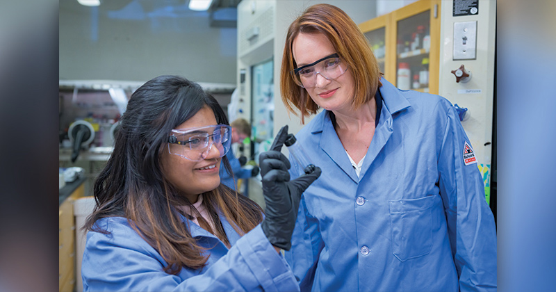 Laure Kayser (right), an assistant professor in the College of Engineering’s Department of Materials Science and Engineering and doctoral candidate Vidhika Damani working in the lab with PEDOT:PSS, a polymer with the unique ability to conduct both electrons and ions.