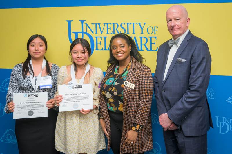 Carla Roblero-Morales and Helen Sandoval Ramos of Sussex Central High School, award winners in the Children’s Literature, Spanish varsity category, accept their CEHD-sponsored award with Deandra Taylor, academic program manager for CEHD’s Teachers of Tomorrow program in UD’s Center for Excellence and Equity in Teacher Preparation, and Gary T. Henry, dean of CEHD.