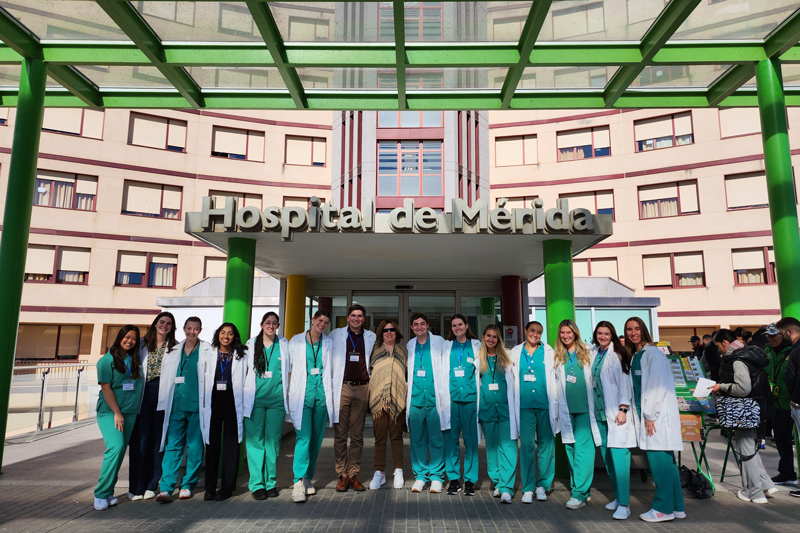 College of Health Sciences and College of Arts and Sciences students pose with Virginia Hughes (middle), associate professor of medical and molecular sciences, outside Hospital de Mérida in Spain, where they spent 75 hours shadowing physicians.  