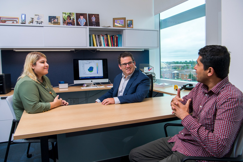 From left to right, Yasmin Moghadamnia, UD doctoral student, meets with her adviser and CBB Executive Committee member Ryan Zurakowski and with Abhyudai Singh, co-director of the new predoctoral training program in data science. Thirty faculty from UD and Delaware State University are affiliated with the program. 