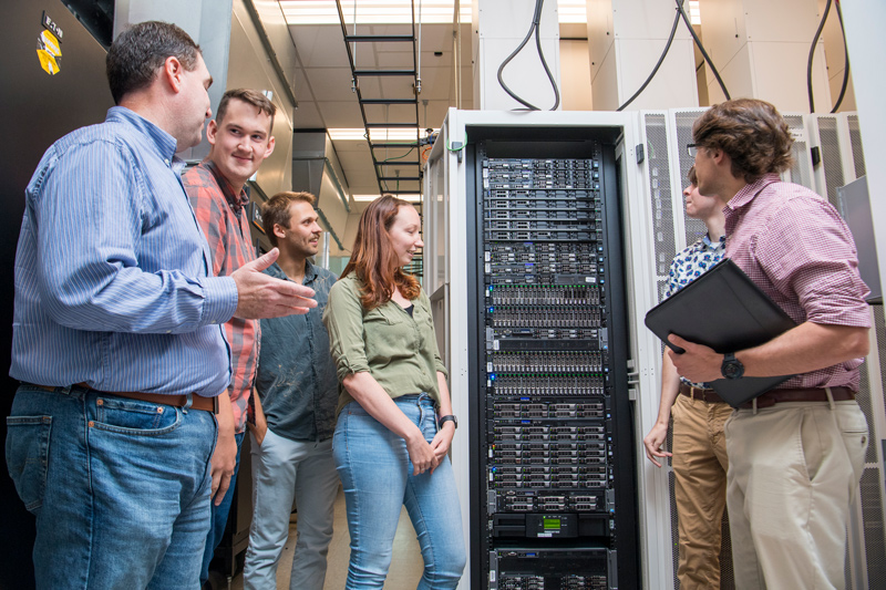 A variety of computational resources are available to students in the new predoctoral training program in data science at UD. Program director Shawn Polson (left) describes the Biomix computational cluster while giving a tour of the data center at the Ammon Pinizzotto Biopharmaceutical Innovation Center to, from left to right, Jonathan Hicks, Joel Turk, Rachel Keown, Patrick Dopler and Anthony Shepherd. Biomix is hosted with support from Delaware INBRE and the Delaware Biotechnology Institute. 
