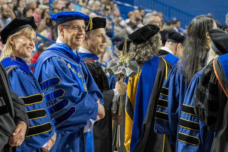 From left to right, UD Provost Laura Carlson, President Dennis Assanis and Graduate College Dean Lou Rossi join the graduates at the Doctoral Hooding Ceremony.