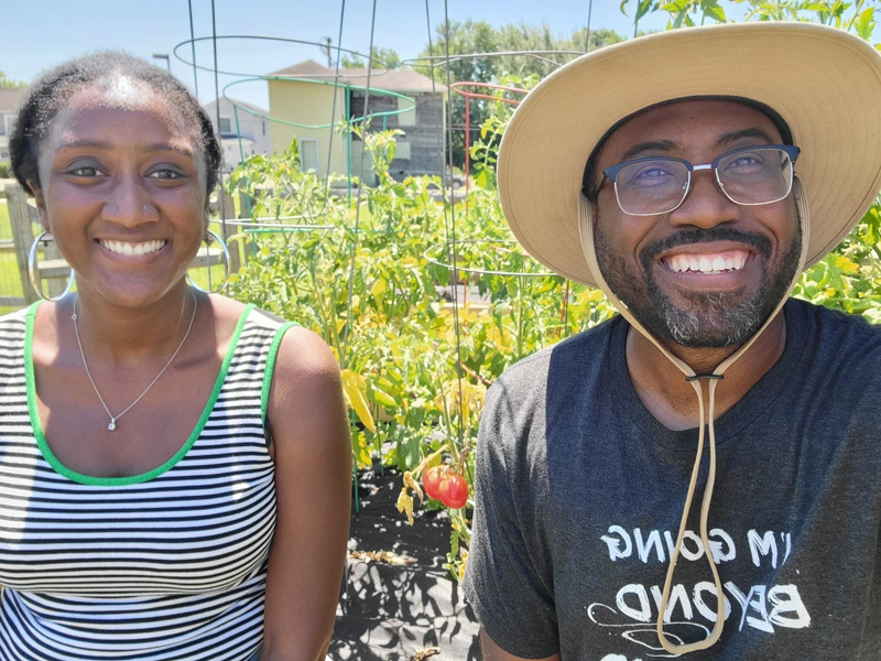 Austen-Monet McClendon (left) works with Reverend Heber Brown, III, founder of the Black Church Food Security Network. 