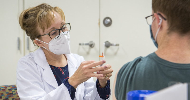 Cindy Haney, an ACME pharmacist, administers a vaccine at a clinic