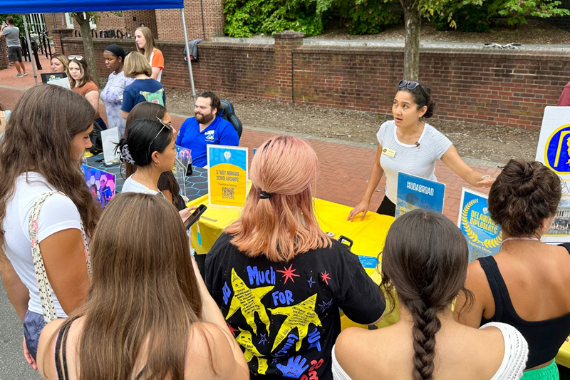 Vina Titaley, associate director of international student engagement and success, talks with students about global events such as International Coffee Hour and study abroad opportunities at the Involvement Fair.