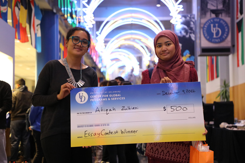 Atiqah Zulhiani (right), an undergraduate student from Malaysia, was presented with a $500 award for winning first place in the 2022 international student essay contest Atiqah Zulhiani (right), an undergraduate student from Malaysia, was presented with a $500 award for winning first place in the 2022 international student essay contest