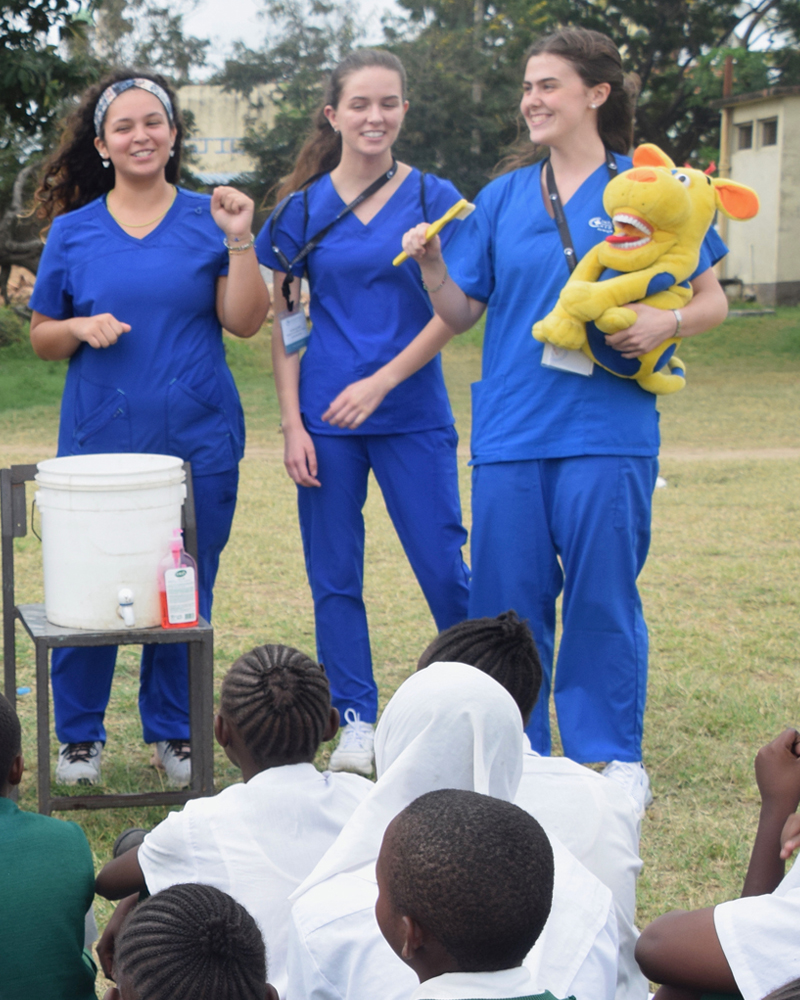 College of Health Sciences senior Katie Hamelin (right) teaches kids at a local Kenya school about proper hygiene, including toothbrushing, along with other interns in the International Medical Aid program. College of Health Sciences senior Katie Hamelin (right) teaches kids at a local Kenya school about proper hygiene, including toothbrushing, along with other interns in the International Medical Aid program.