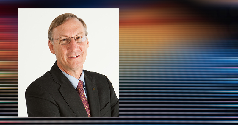 a portrait of researcher Stephen Forrest on top of a background of colored LED lights